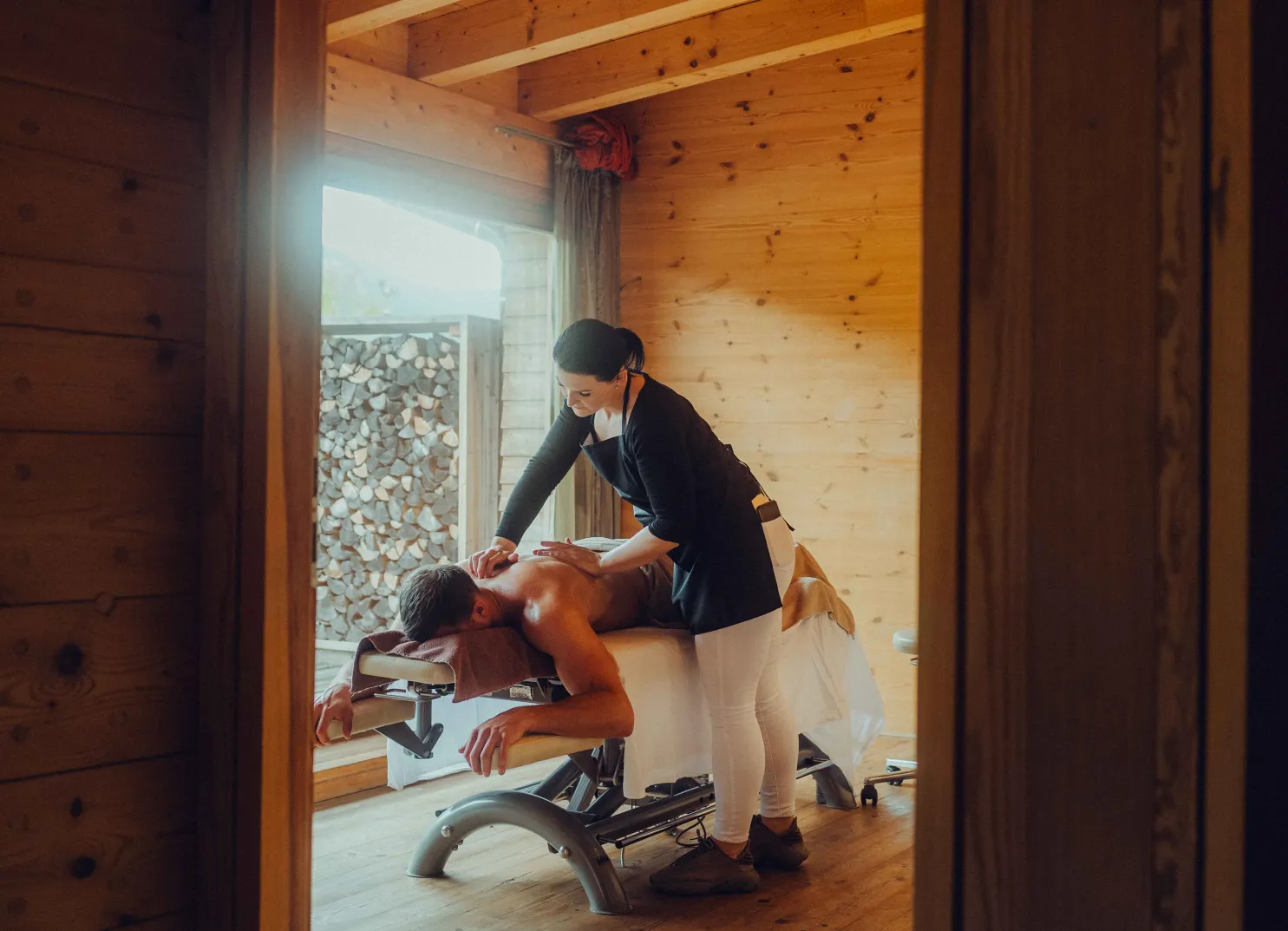 Spa setting with a massage in a wooden room