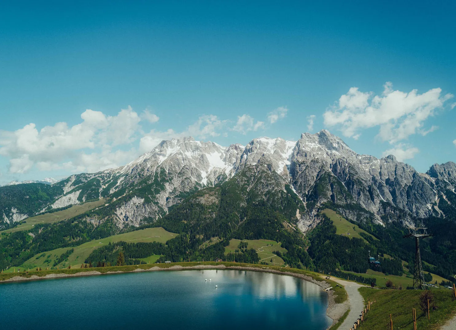 Mountain landscape with lake and green valley in the background