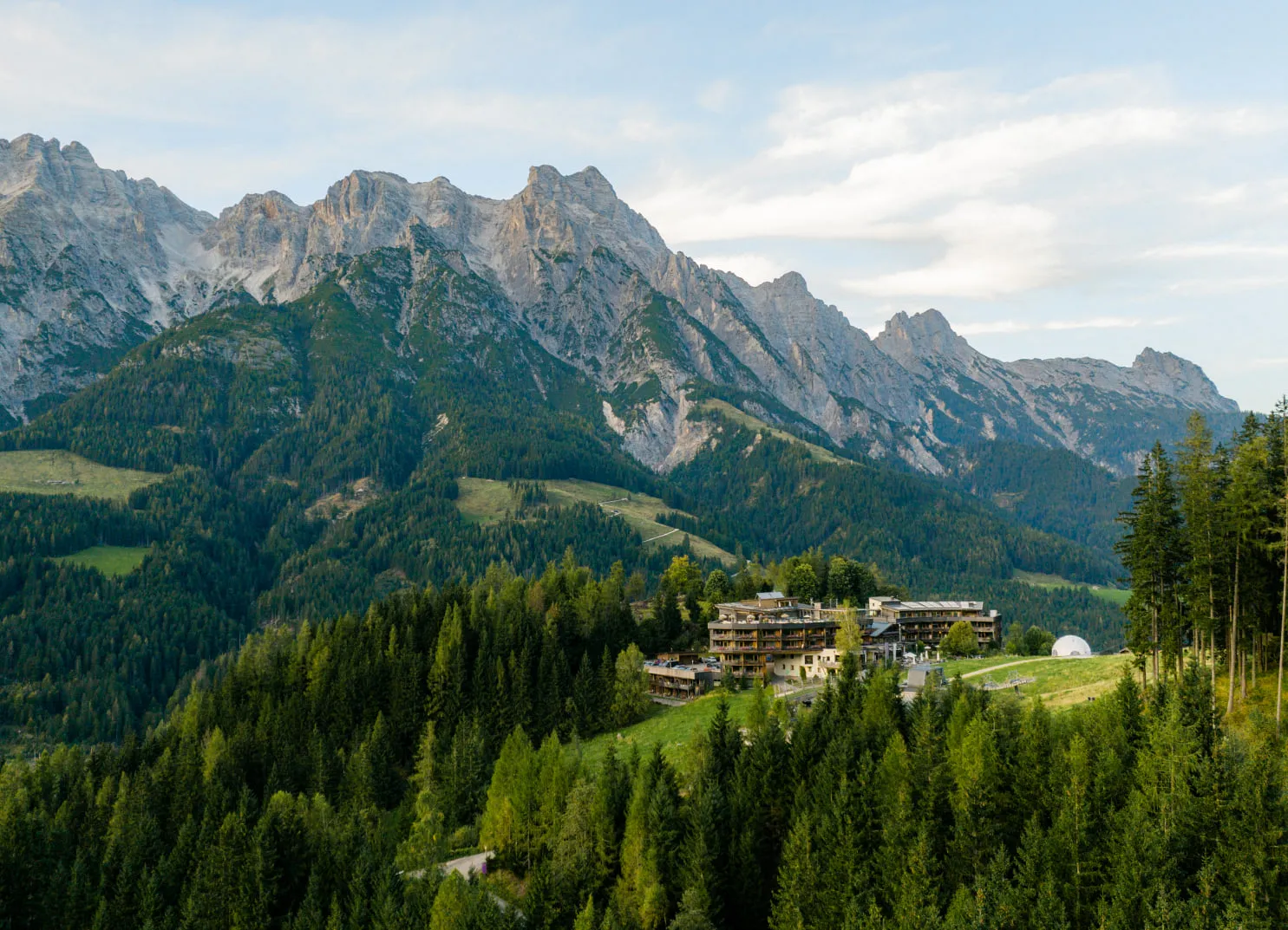 Mountain landscape with hotel and forests