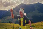 Person wandert in den Bergen mit einem Wanderstock