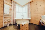 Interior view of a wooden room with a sink and curtains