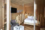 cozy wooden room with bed and TV