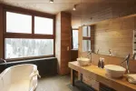 Bright bathroom with wooden panels and large windows