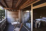 Wooden balcony with chairs and indoor view