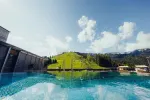 Scenic view of a pool with a green hill backdrop
