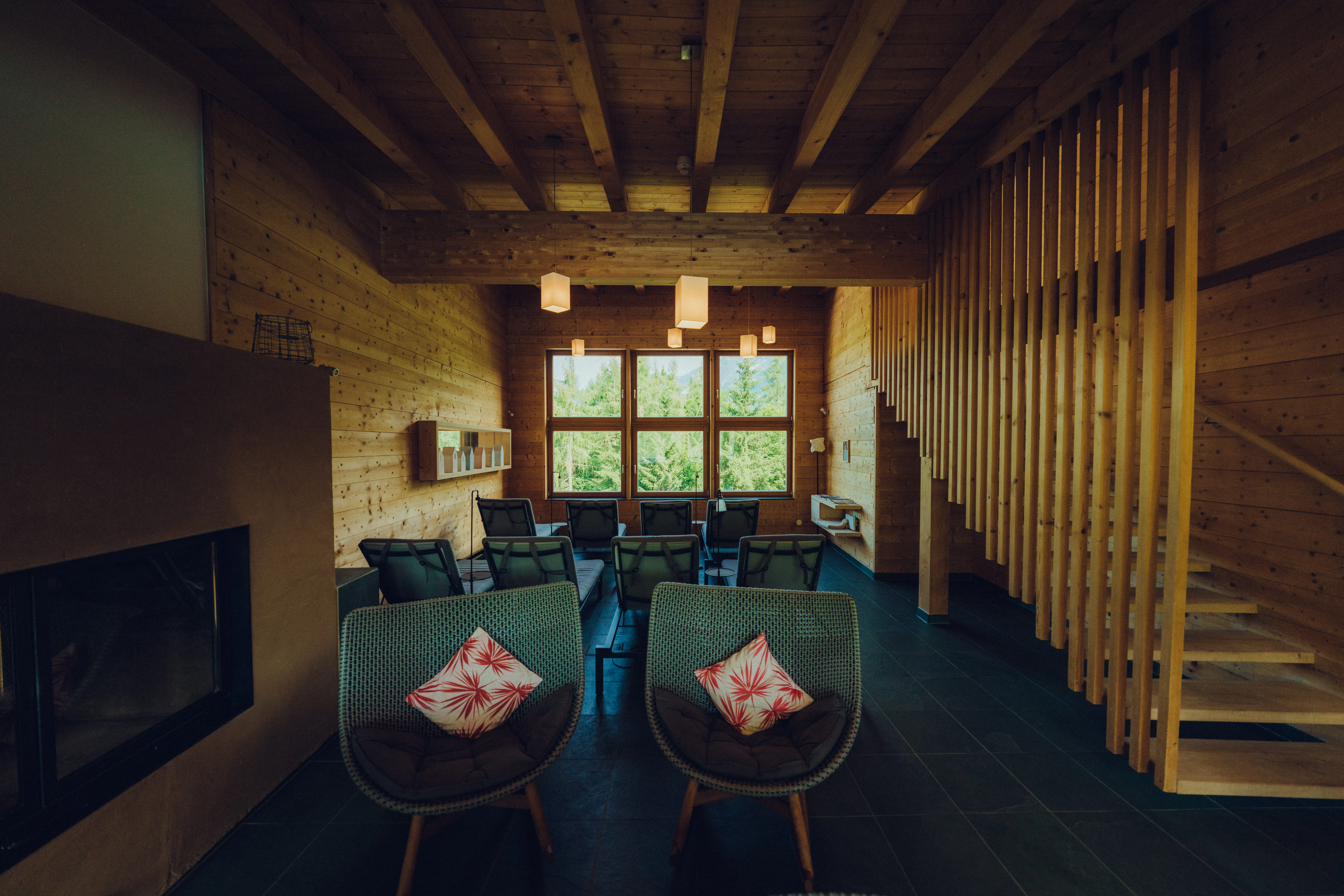 Cozy interior of a wooden spa with chairs and a staircase