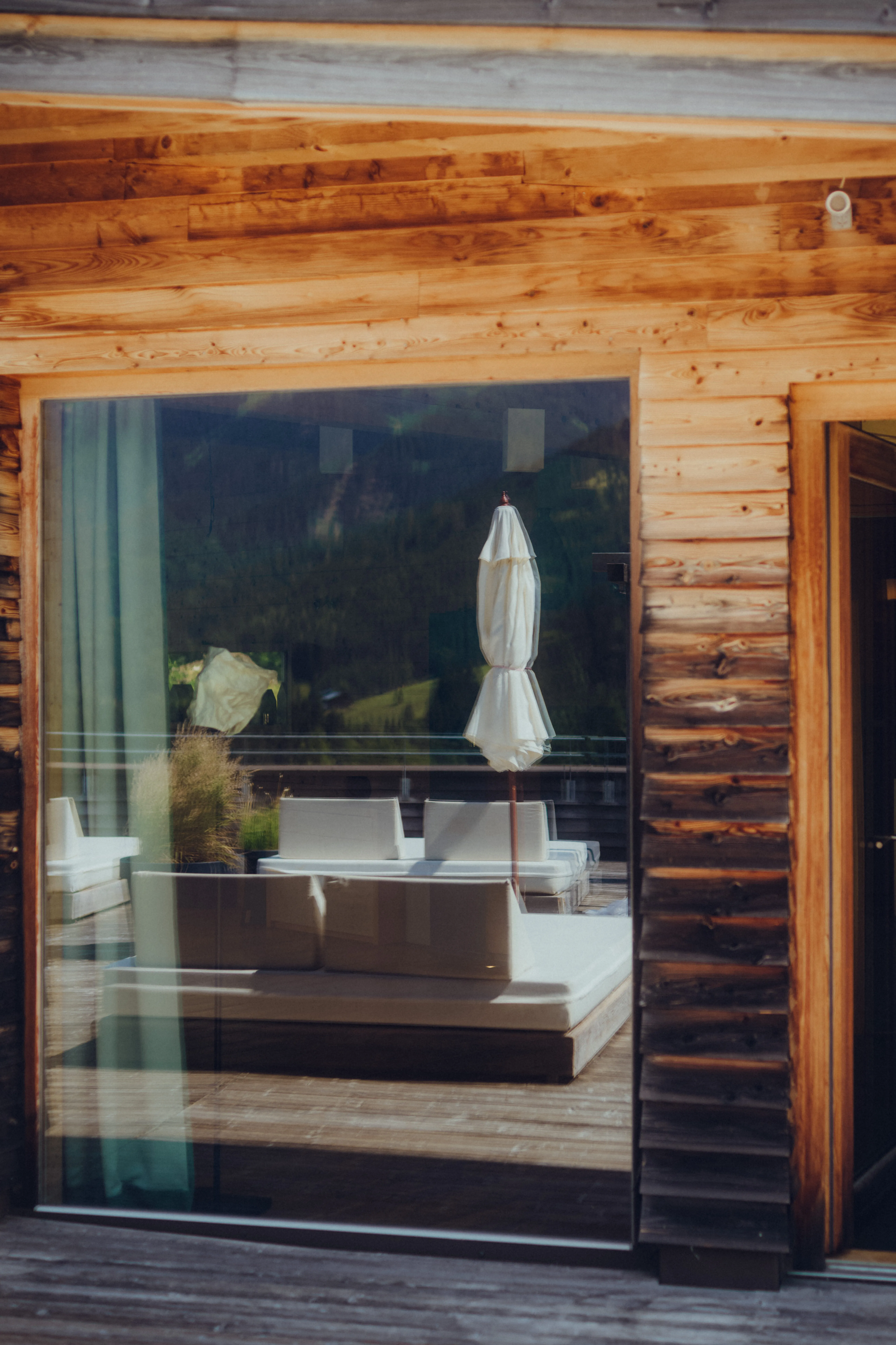 Reflection of a cozy seating area with a white sofa in a wooden structure
