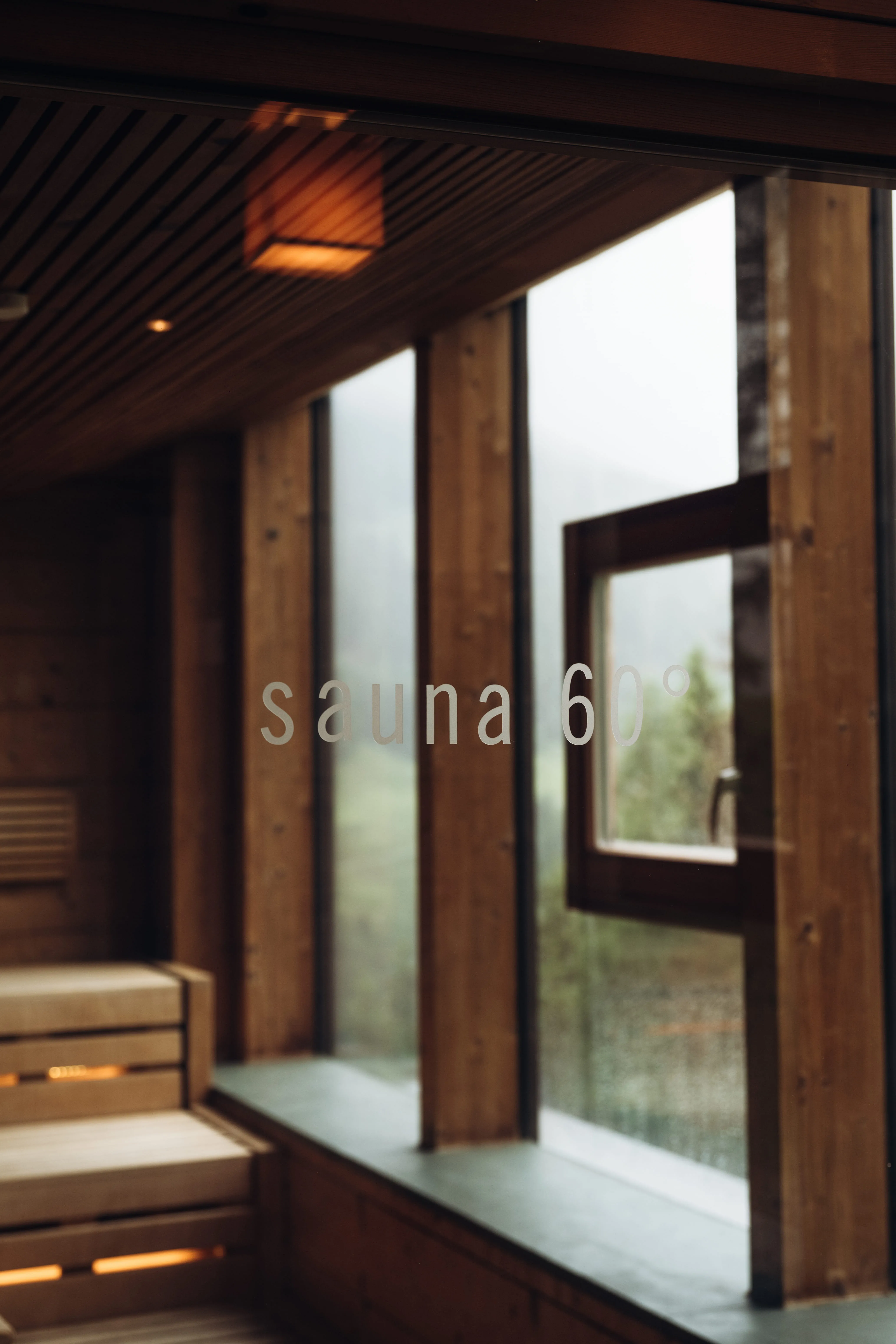 Interior of a sauna with wooden walls and large windows