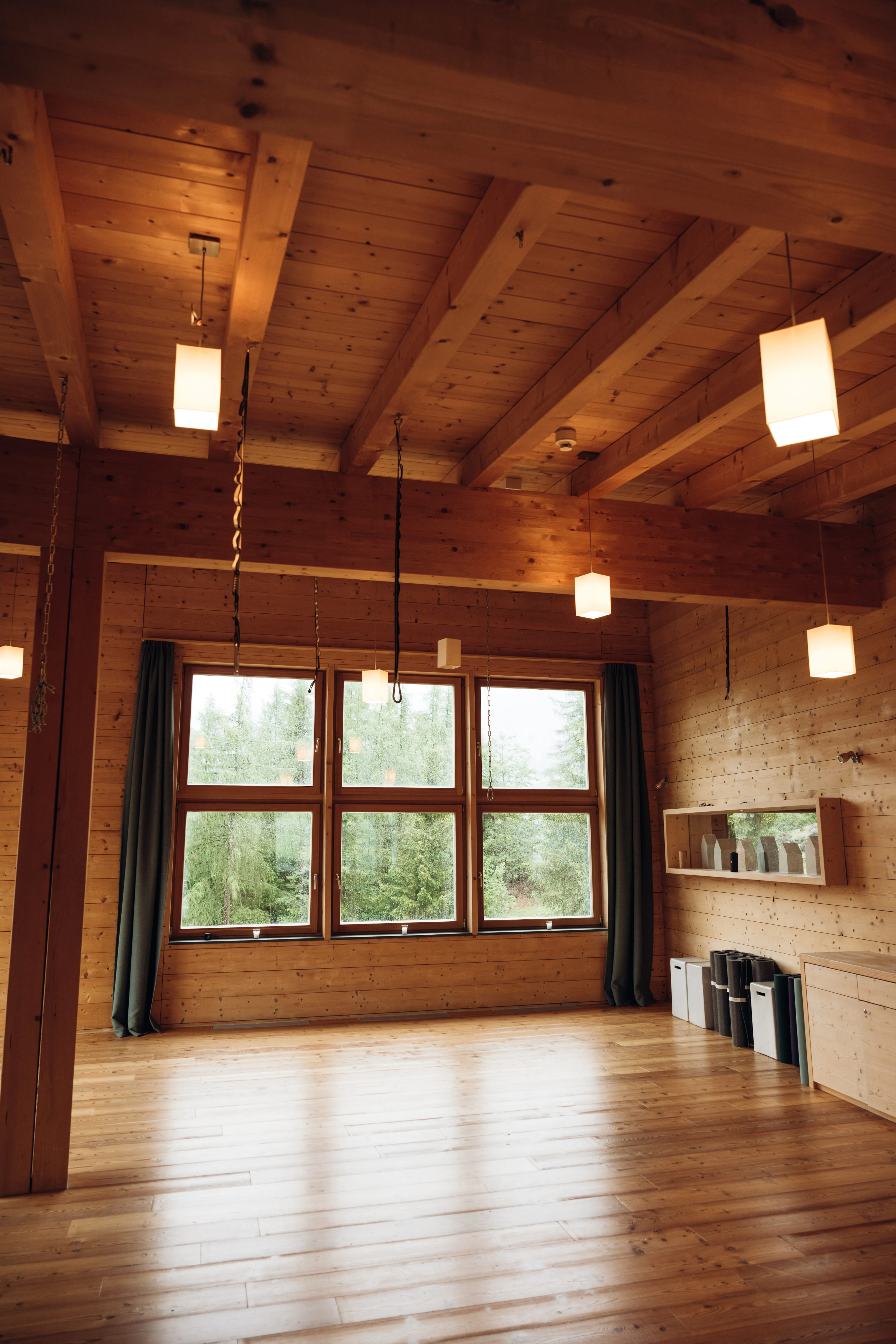 Wooden room with large windows and modern lighting