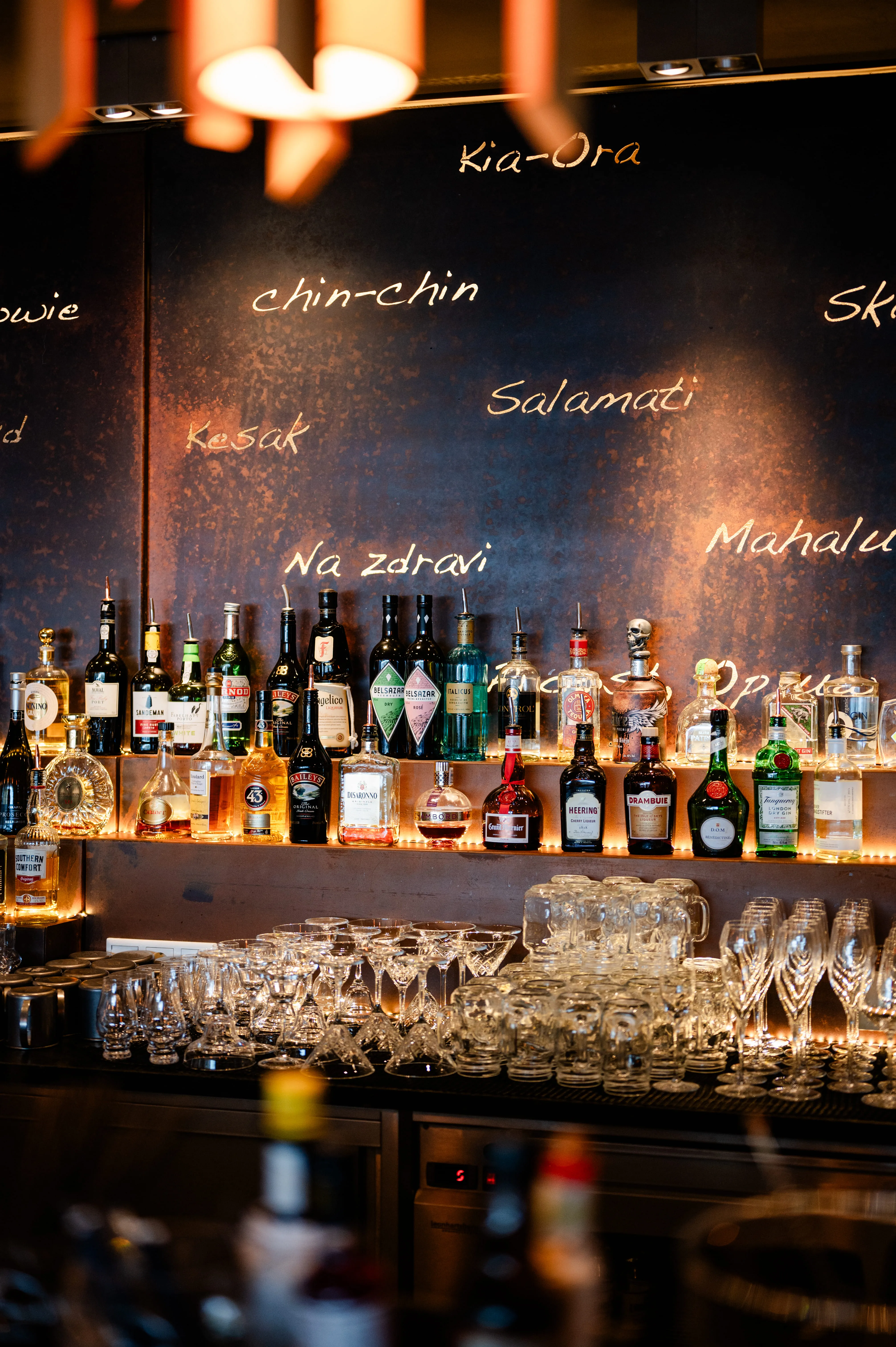 A bar with various bottles of liquor and glassware on display