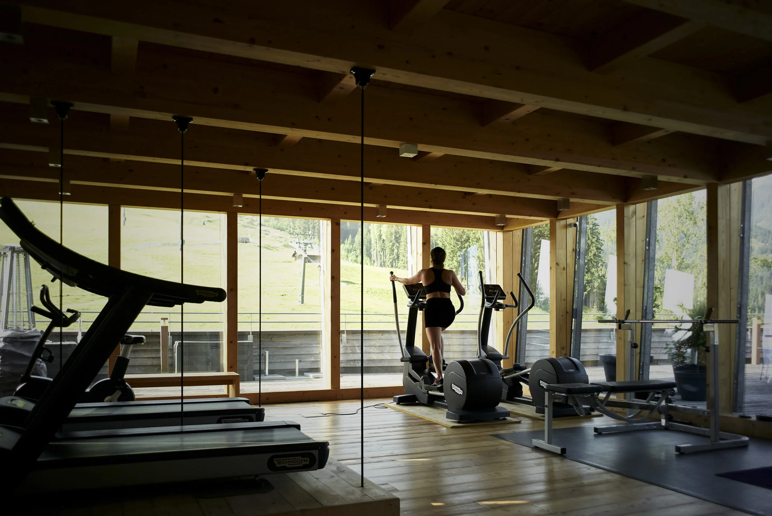 gym interior with exercise equipment and a person training
