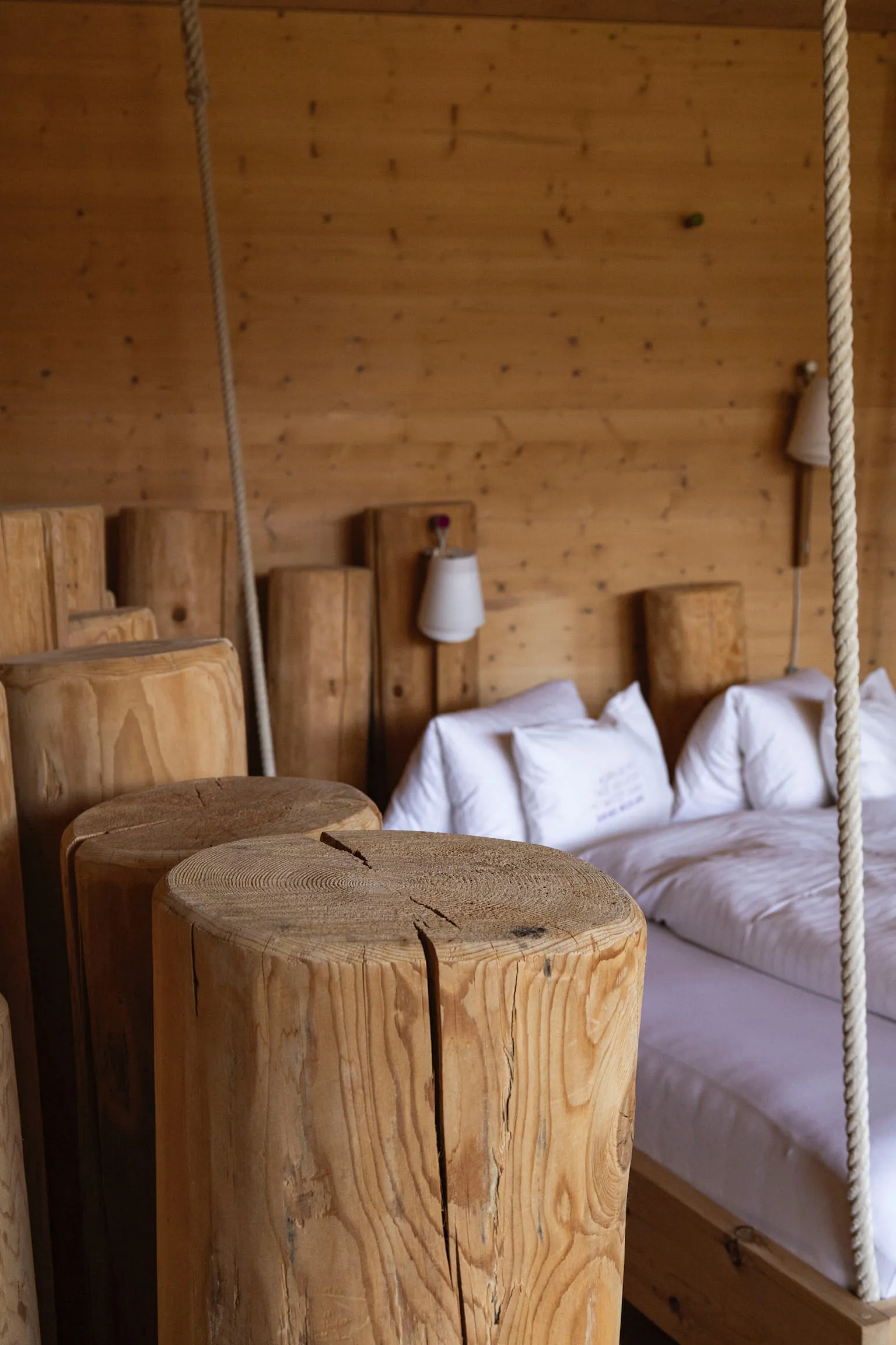 Wooden pillars and a bed area in a wooden room