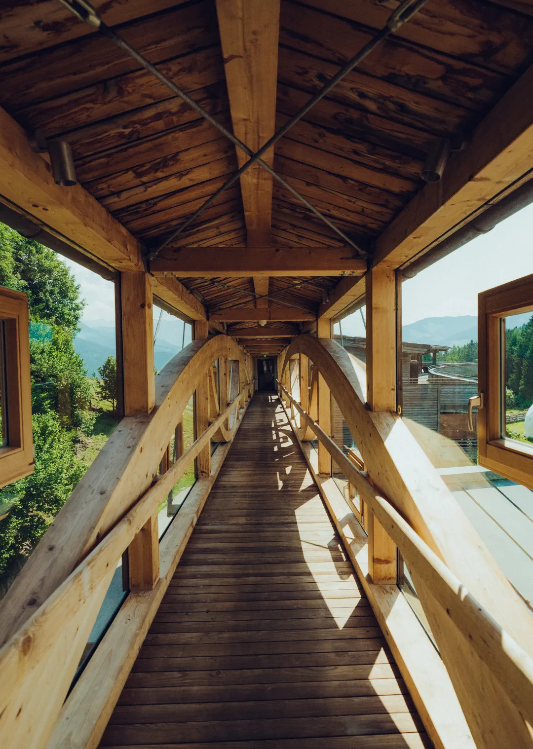 Wooden walkway with arches and large windows