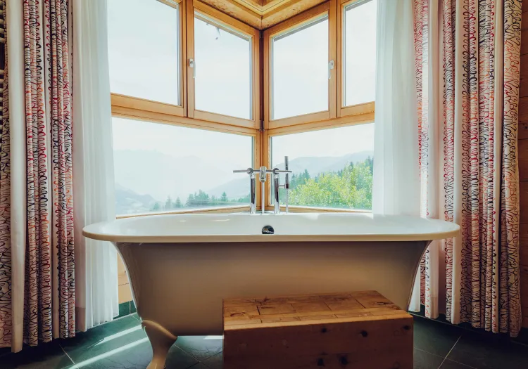 Bathroom with freestanding bathtub and window view