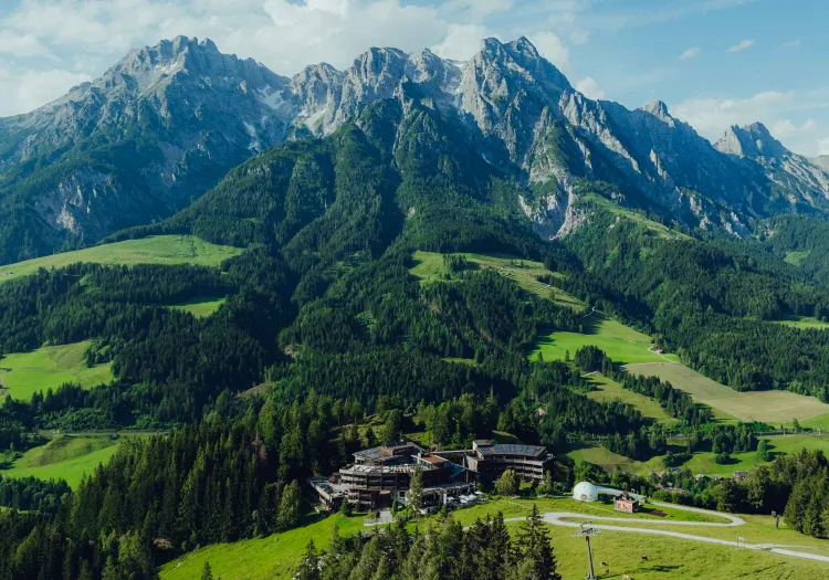 Mountain landscape with peaks and a building in the foreground