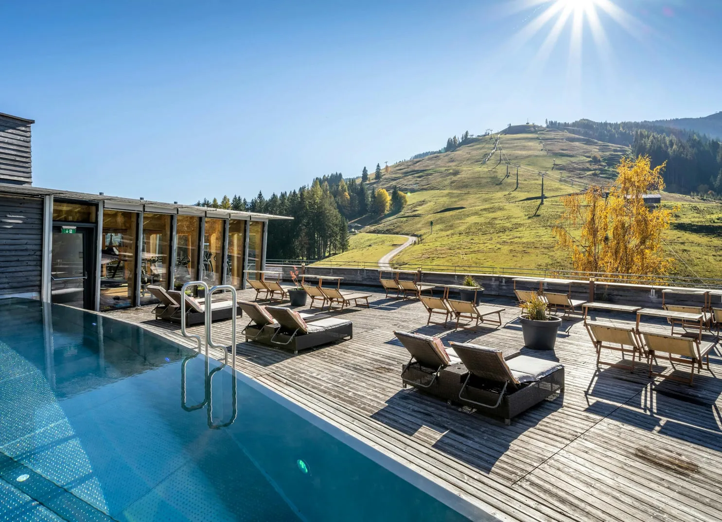 Modern terrace with swimming pool and view of the autumn landscape.