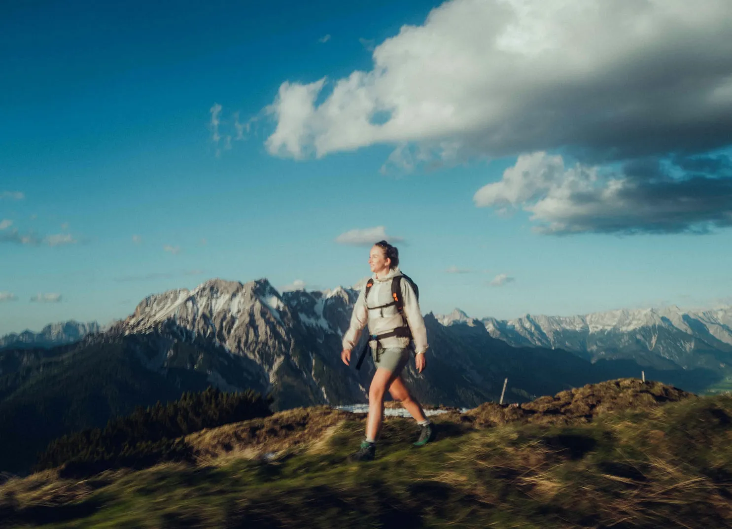 Woman hiking on a mountain landscape with a view of the peaks