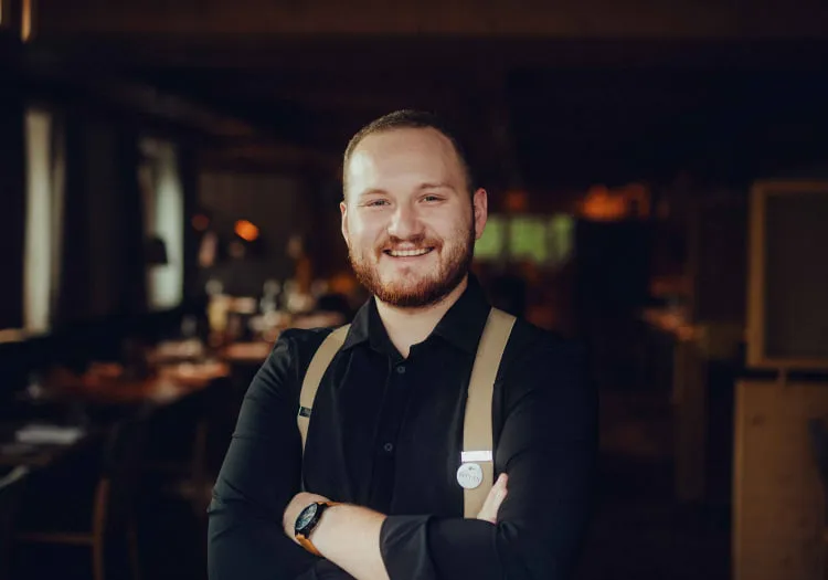 Smiling man in a restaurant with wooden interior