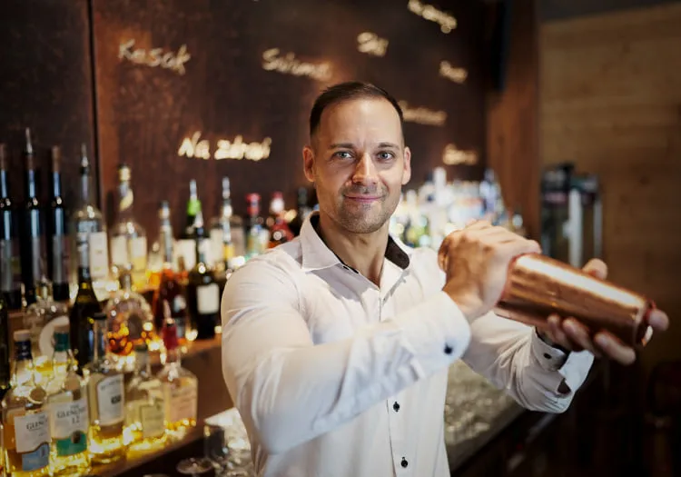 Bartender with shaker at Holzhotel Forsth