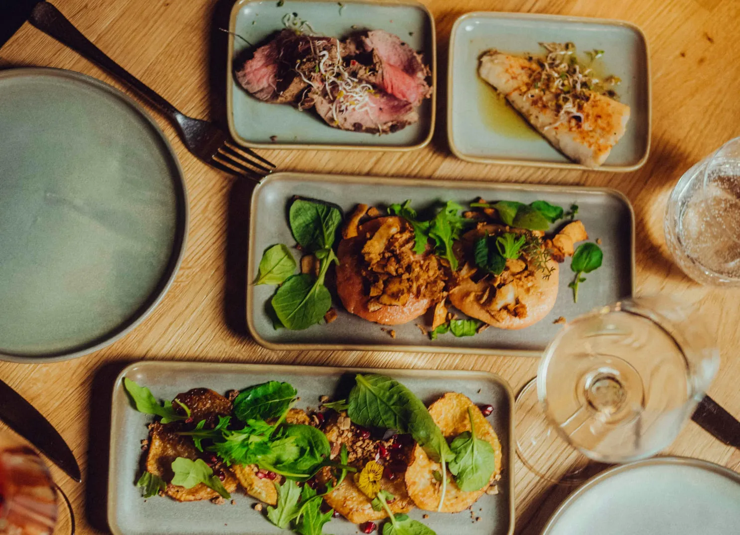 Various dishes served on plates with fresh herbs and garnishes