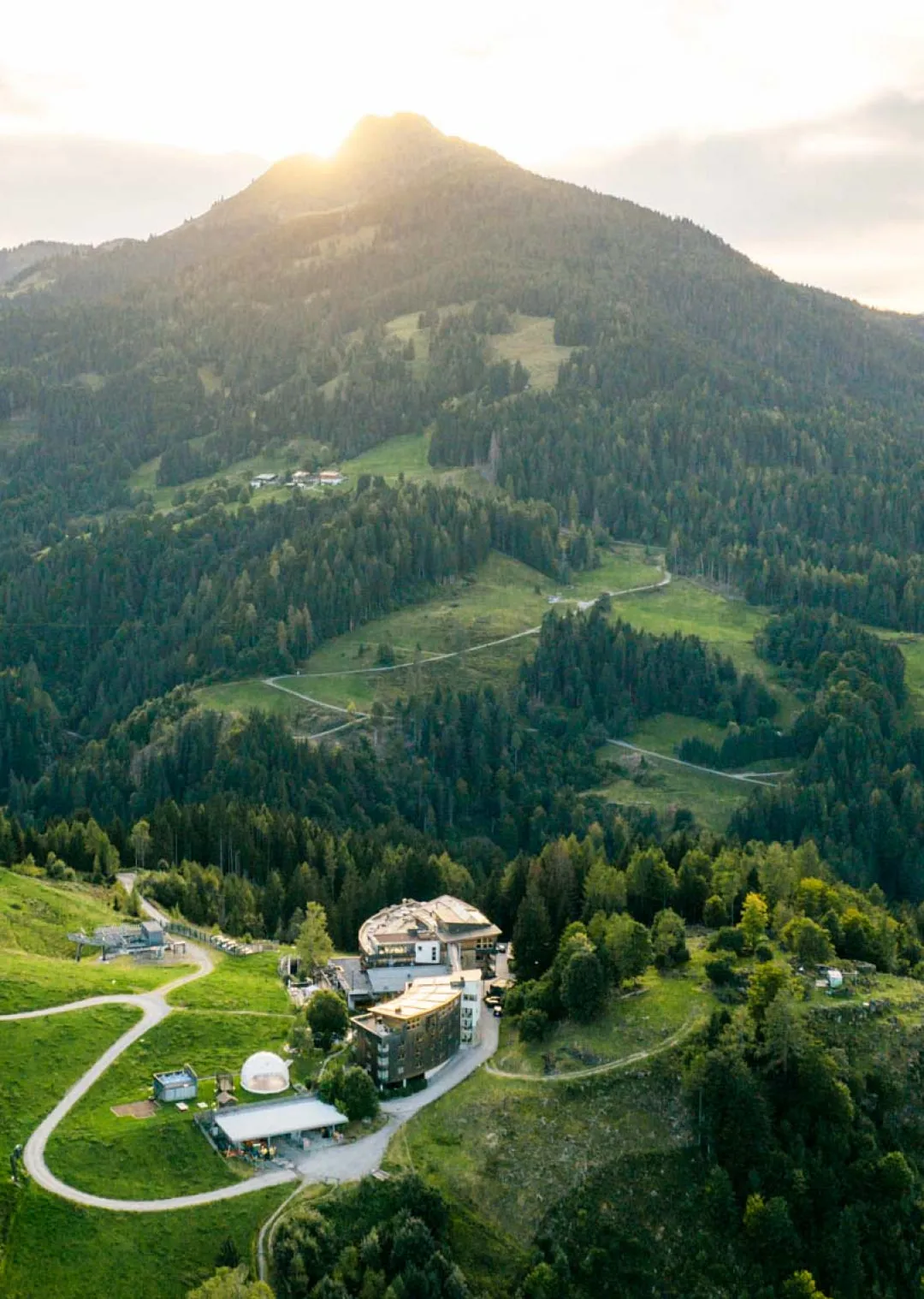 Aerial view of Holzhotel Forsthofalm in Leogang and surrounding mountains