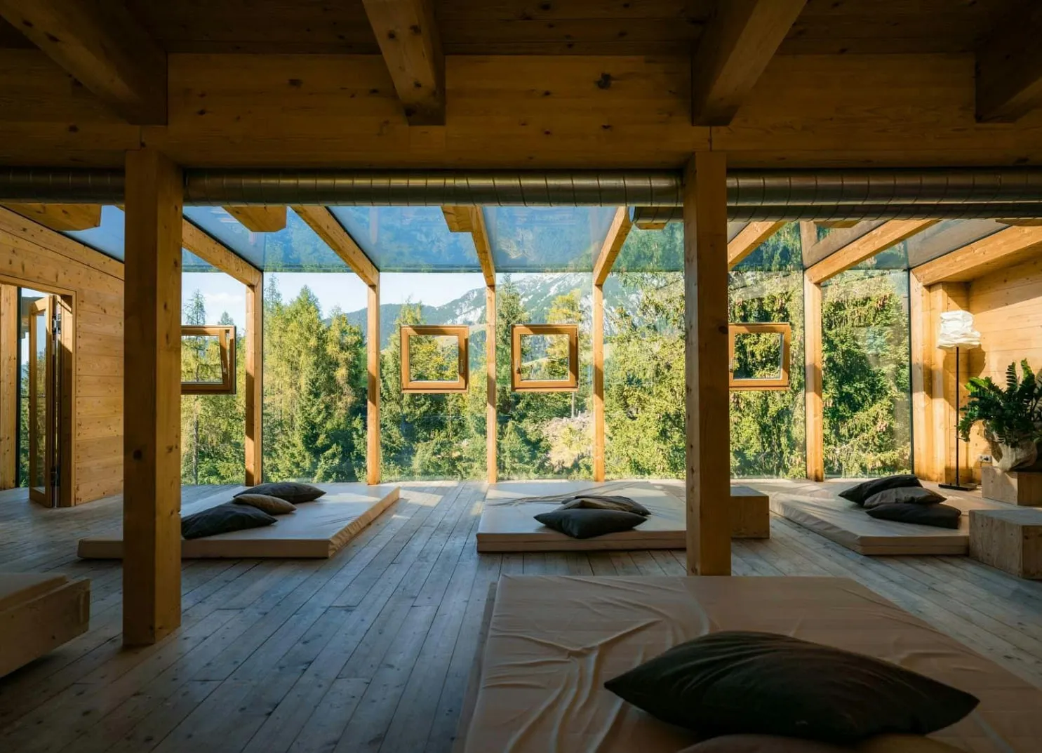 Wooden room with seating and large windows for the view.