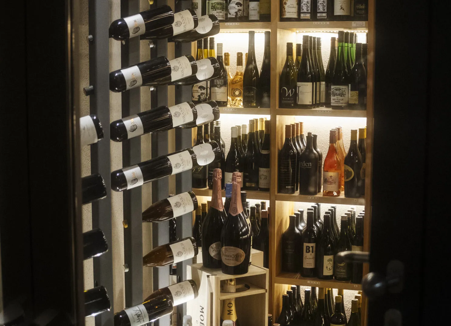 Wine rack with various wines in Holzhotel Forsthofalm, Leogang