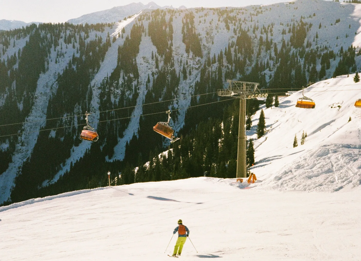 Skier on the slope with ski lifts in the background in Leogang during winter