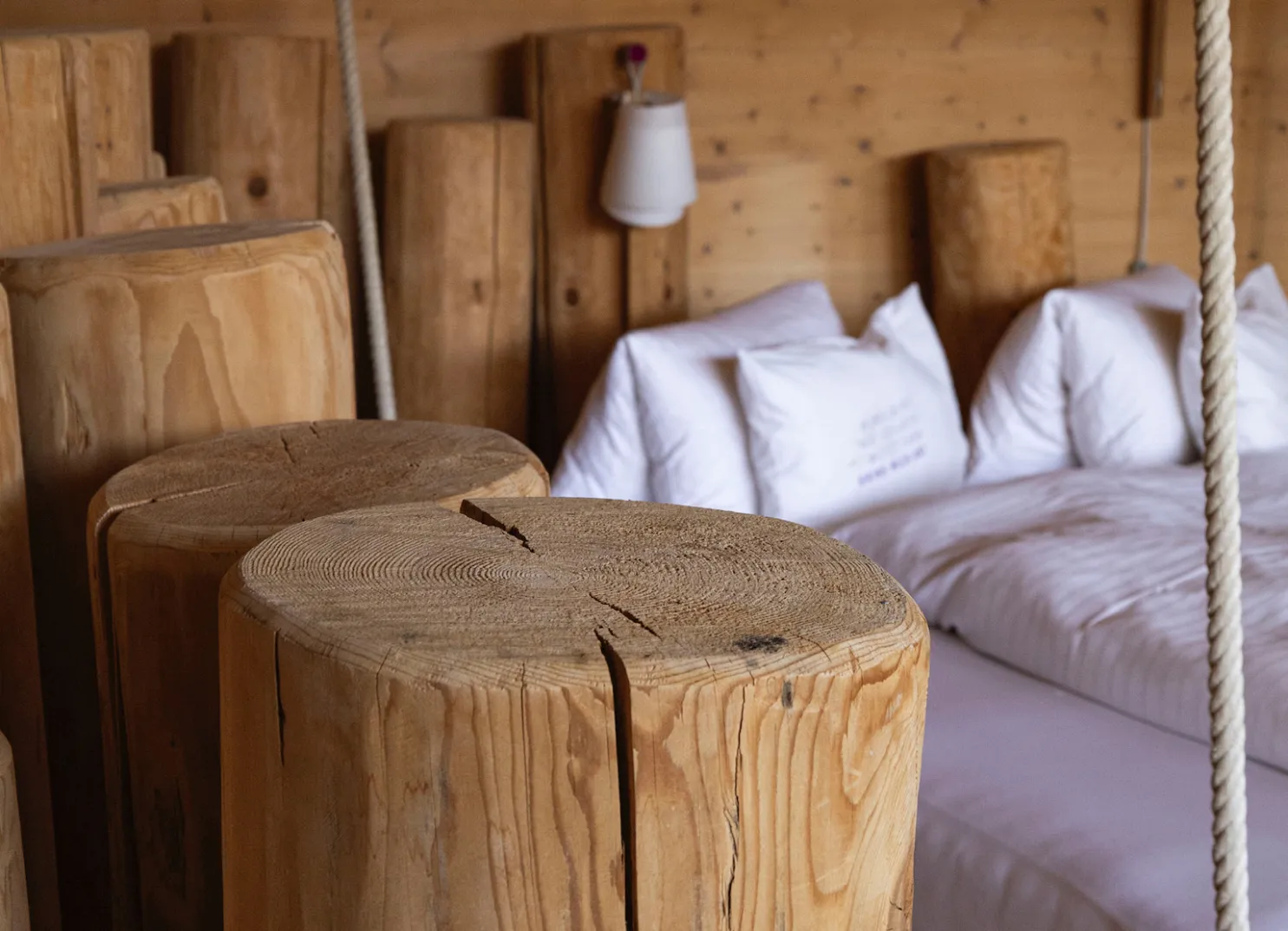 Wood logs and beds in a rustic interior